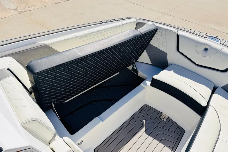 Slide: The Image of 2023 Nautique Super Air Nautique G25 interior seating with storage compartment open. - 19