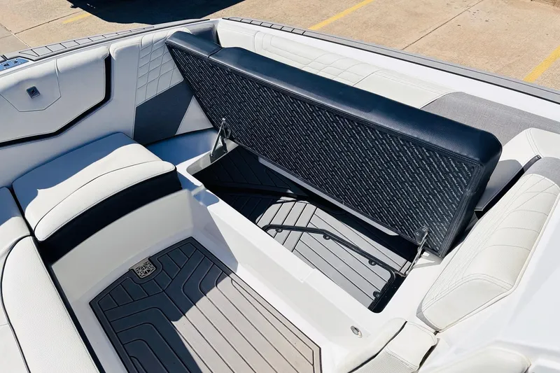 Slide: The Image of 2023 Nautique Super Air Nautique G25 interior with open storage compartment. - 20