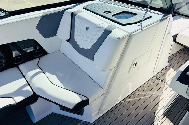 Slide: The Image of 2023 Nautique Super Air Nautique G25 interior seating with modern design and cup holders. - 27