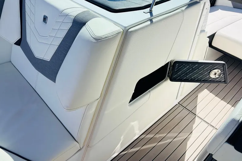 Slide: The Image of 2023 Nautique Super Air Nautique G25 interior with open storage compartment. - 28