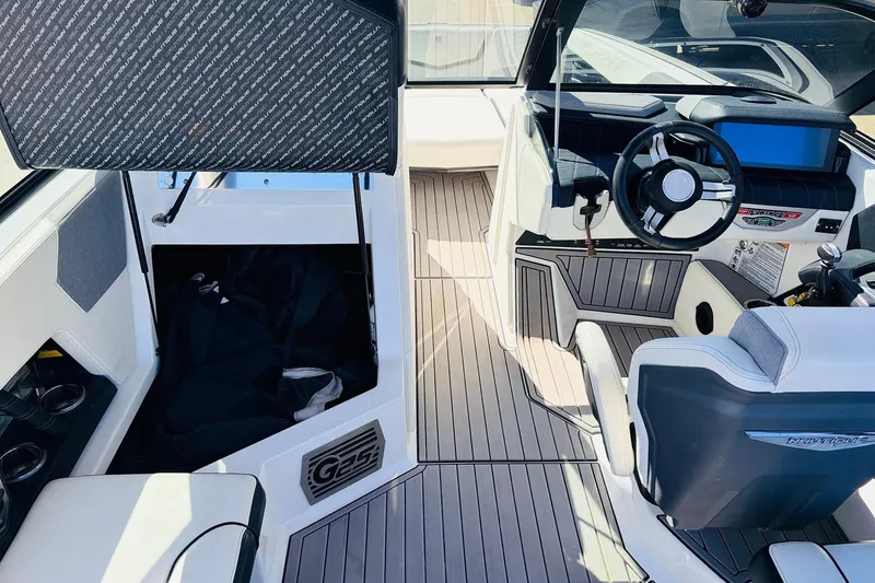 Slide: The Image of 2023 Nautique Super Air Nautique G25 interior with modern helm and seating. - 29