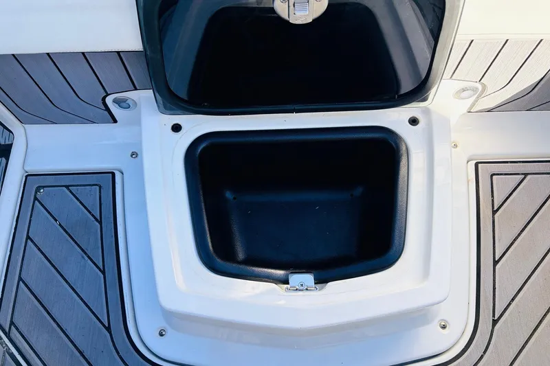 Slide: The Image of 2023 Nautique Super Air Nautique G25 storage compartment with open lid on deck. - 39