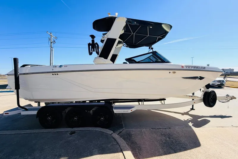Slide: The Image of 2023 Nautique Super Air Nautique G25 boat on trailer, sunny day. - 4