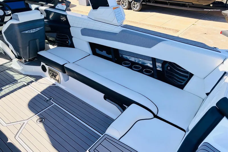 Slide: The Image of 2023 Nautique Super Air Nautique G25 interior with white seating and modern dashboard. - 40