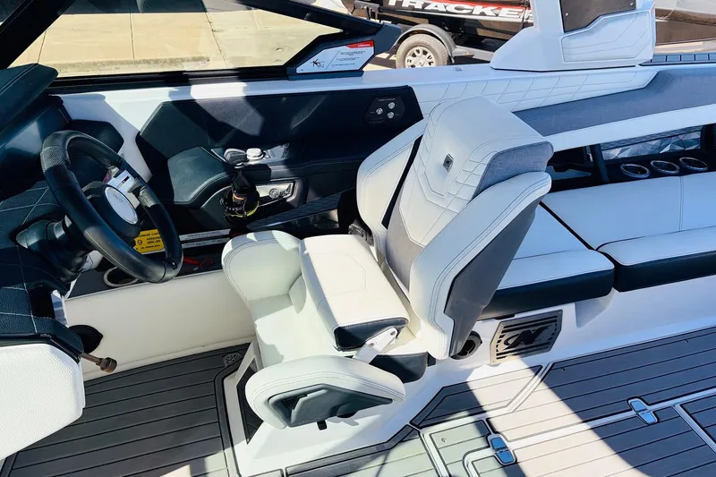 Slide: The Image of 2023 Nautique Super Air Nautique G25 interior with steering wheel and seating. - 44