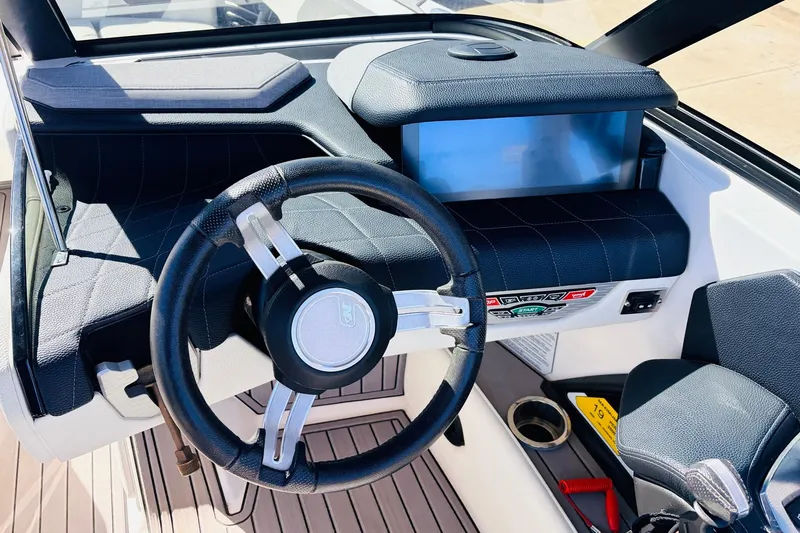 Slide: The Image of 2023 Nautique Super Air Nautique G25 dashboard with steering wheel and control panel. - 45