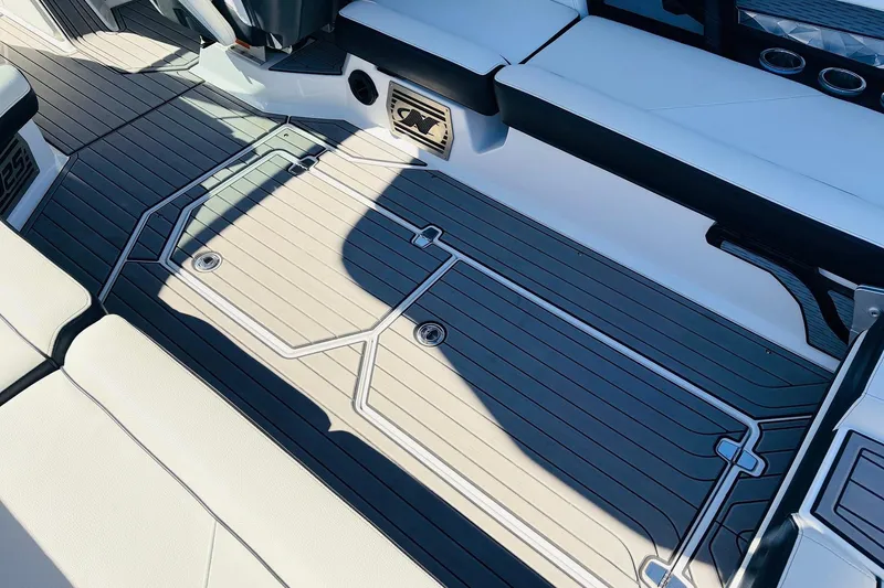 Slide: The Image of 2023 Nautique Super Air Nautique G25 interior with sleek, modern seating and flooring design. - 48