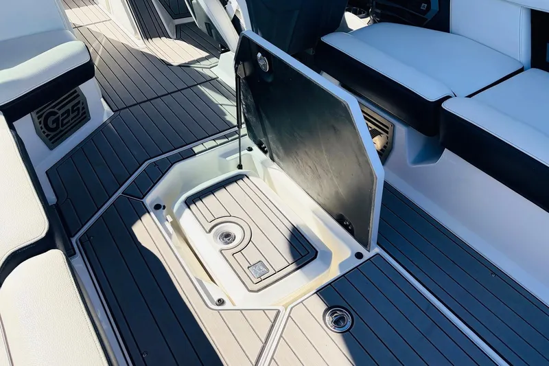 Slide: The Image of 2023 Nautique Super Air Nautique G25 interior with open storage compartment. - 49