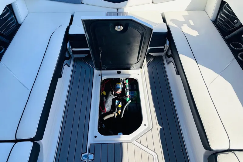 Slide: The Image of 2023 Nautique Super Air Nautique G25 interior with open storage compartment. - 52