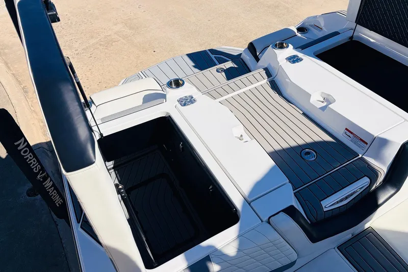 Slide: The Image of 2023 Nautique Super Air Nautique G25 boat deck with storage compartments and seating. - 55
