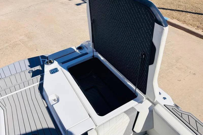 Slide: The Image of 2023 Nautique Super Air Nautique G25 open storage compartment on deck. - 56