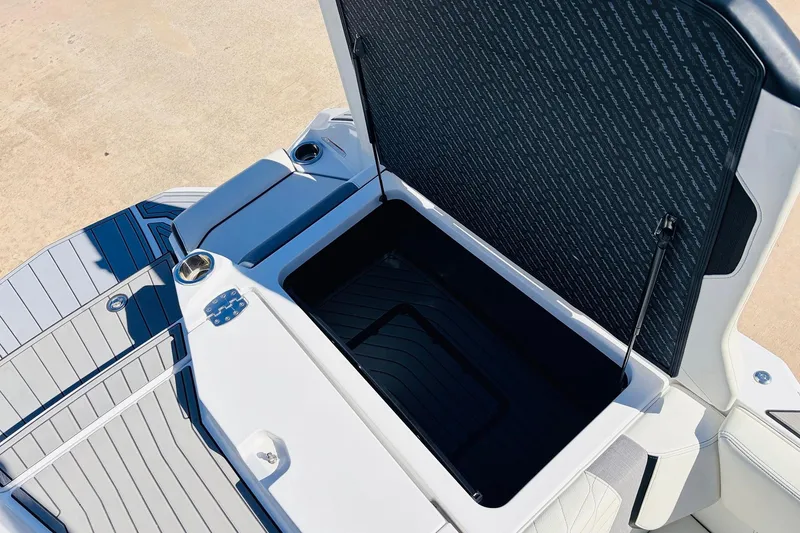 Slide: The Image of 2023 Nautique Super Air Nautique G25 boat storage compartment open, showcasing interior space. - 57