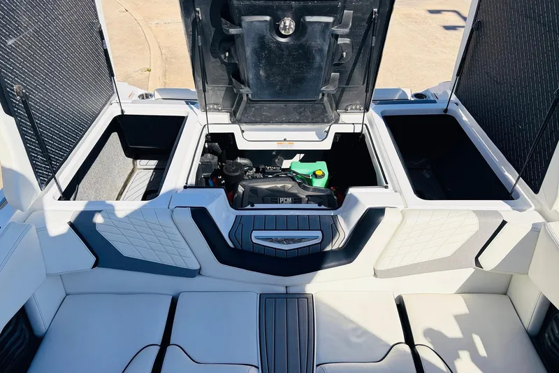 Slide: The Image of 2023 Nautique Super Air Nautique G25 engine compartment with open storage hatches. - 58