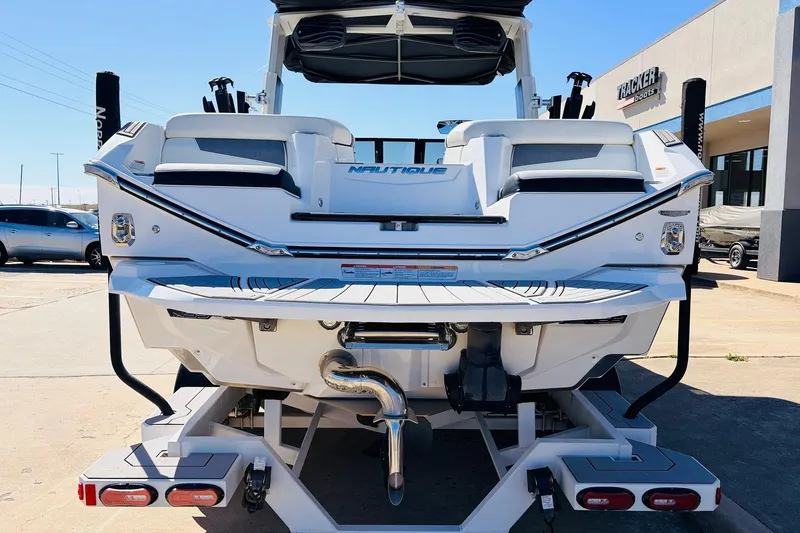 Slide: The Image of 2023 Nautique Super Air Nautique G25 boat rear view at dealership. - 6