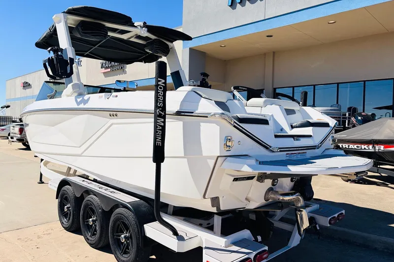 Slide: The Image of 2023 Nautique Super Air Nautique G25 boat on trailer at dealership. - 7