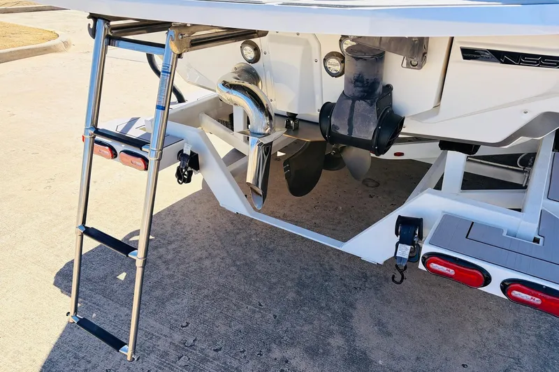 Slide: The Image of 2023 Nautique Super Air Nautique G25 boat rear view with ladder and propeller. - 8