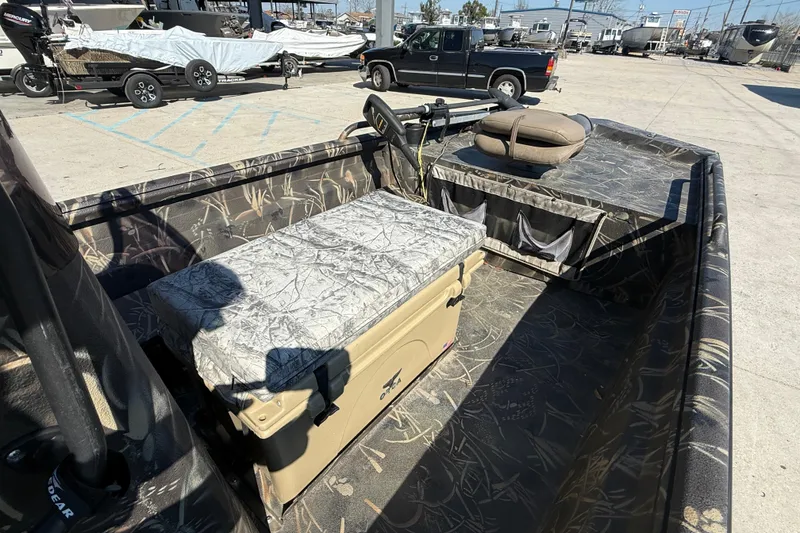 Slide: The Image of 2018 Excel F86 boat interior with camouflage design, featuring seating and storage. - 10