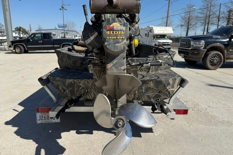Slide: The Image of Boat with camo design and Mud Buddy HDR 4400 EFI motor on trailer. - 5