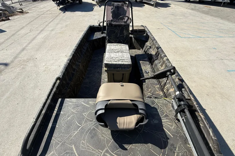 Slide: The Image of 2018 Excel F86 boat with camouflage interior, parked on concrete surface. - 8