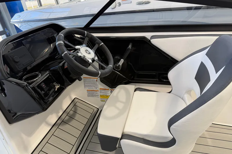 Slide: The Image of 2025 Yamaha Boats 195S cockpit with steering wheel and modern seating design. - 4