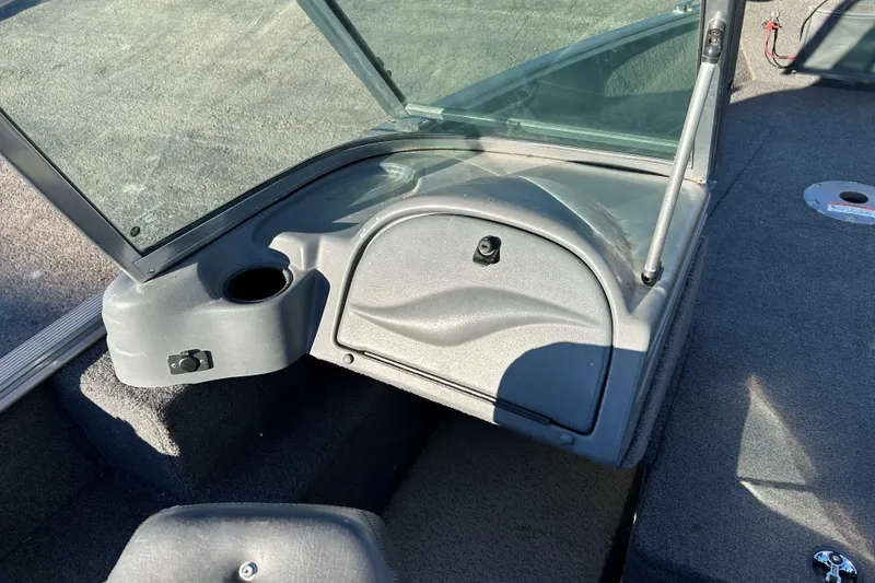Slide: The Image of 2012 Lund 1775 Impact XS boat interior with windshield and storage compartment. - 11