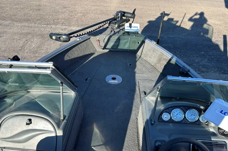 Slide: The Image of 2012 Lund 1775 Impact XS boat interior with steering console and fishing equipment. - 12