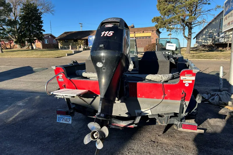 Slide: The Image of 2012 Lund 1775 Impact XS boat with outboard motor, parked outdoors. - 5