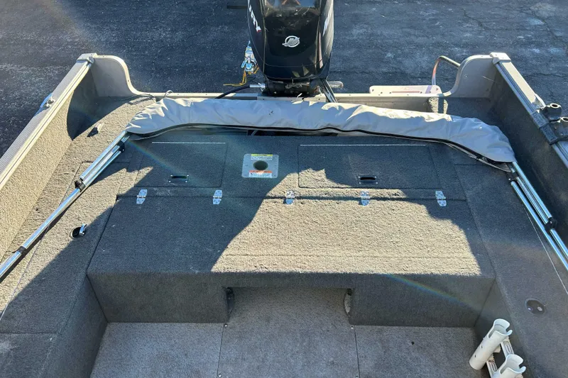 Slide: The Image of 2012 Lund 1775 Impact XS boat interior with motor and storage compartments. - 6