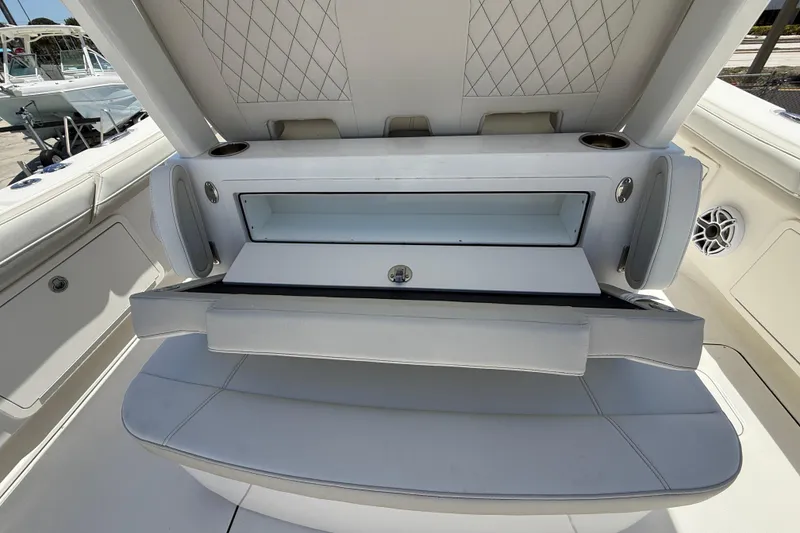 Slide: The Image of 2026 World Cat 325 CC boat interior with seating and storage compartment. - 11
