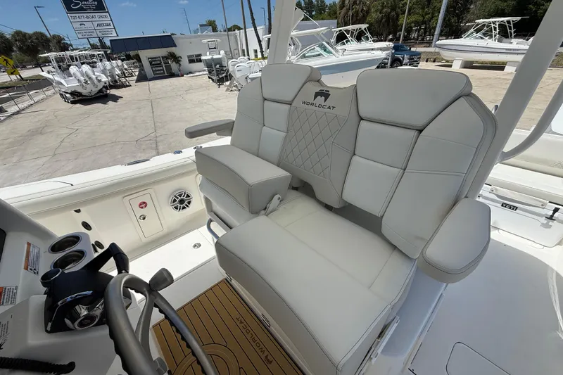 Slide: The Image of 2026 World Cat 325 CC boat interior with plush seating and modern helm controls. - 13