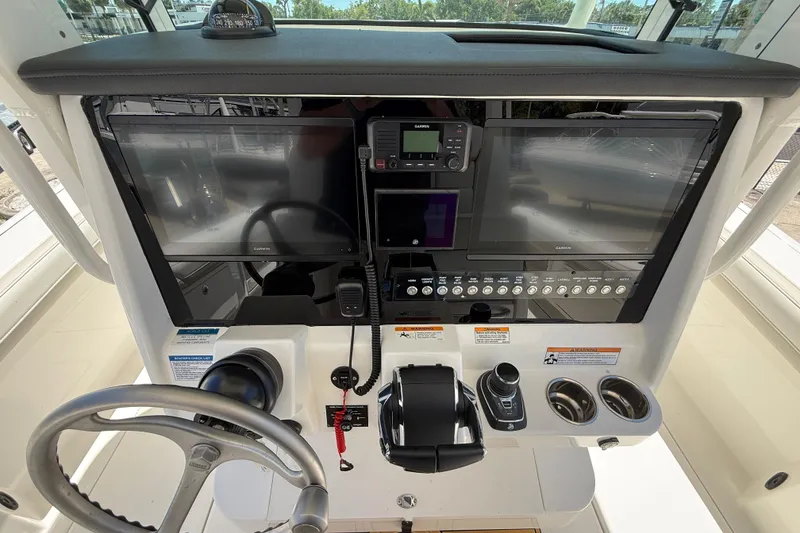 Slide: The Image of 2026 World Cat 325 CC helm with dual Garmin displays and modern controls. - 14