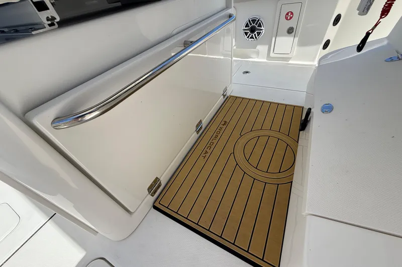 Slide: The Image of Interior of 2026 World Cat 325 CC boat, featuring sleek design and branded mat. - 16