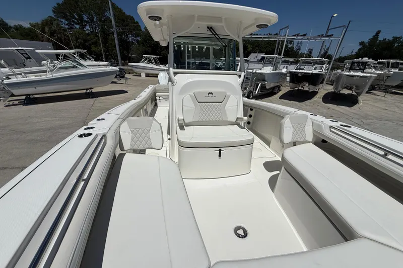 Slide: The Image of 2026 World Cat 325 CC boat interior with white seating and modern design. - 22