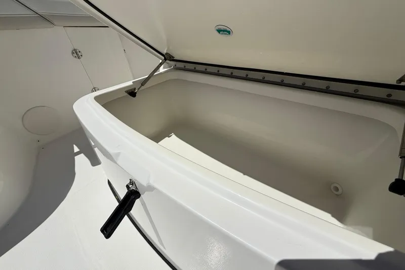 Slide: The Image of Open storage compartment on 2026 World Cat 325 CC boat, showcasing spacious interior design. - 23