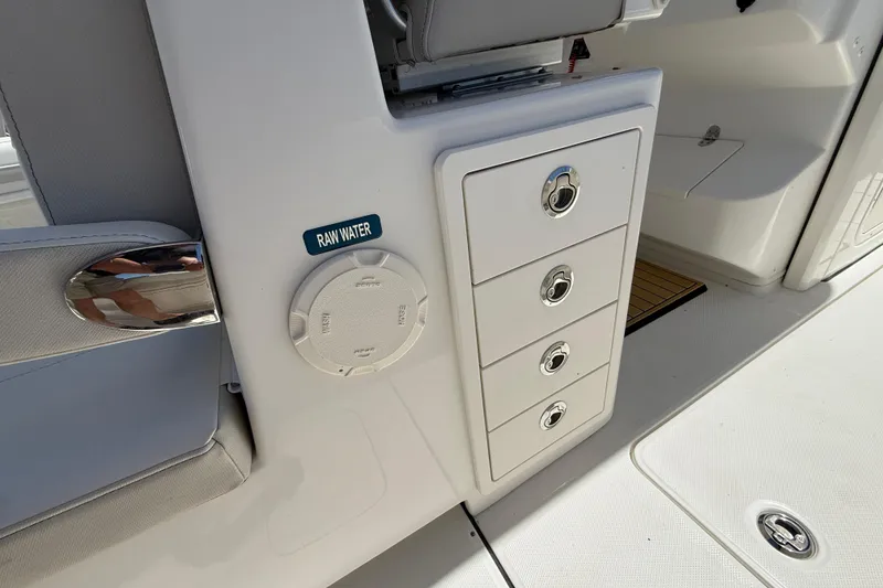 Slide: The Image of 2026 World Cat 325 CC boat interior with storage drawers and raw water access. - 27