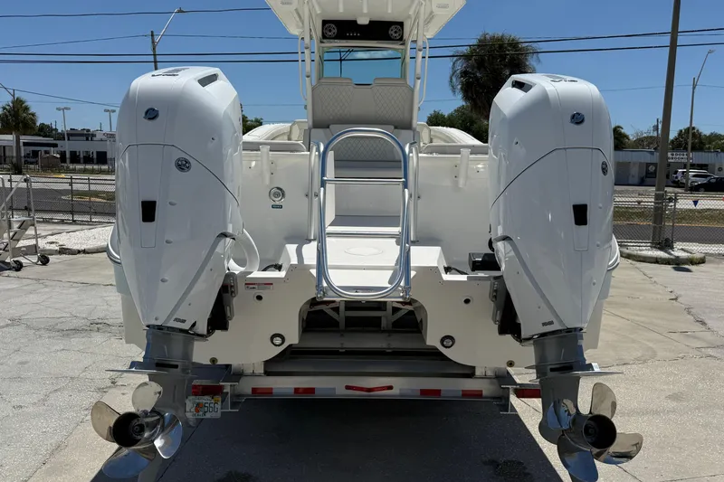 Slide: The Image of 2026 World Cat 325 CC boat with dual outboard engines on a trailer. - 4