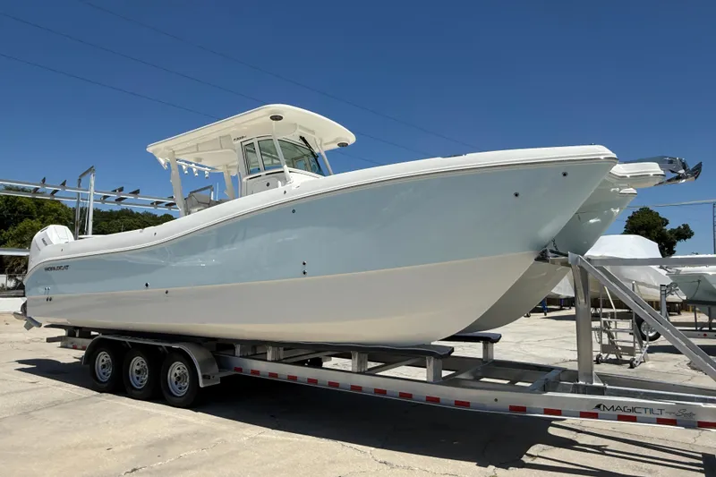 Slide: The Image of 2026 World Cat 325 CC boat on trailer under clear blue sky. - 6