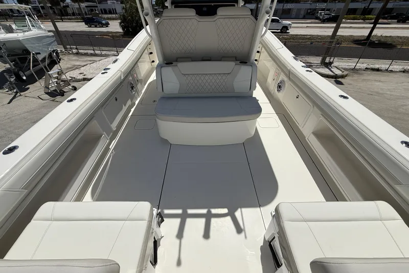 Slide: The Image of 2026 World Cat 325 CC boat interior with white seating and spacious deck. - 9