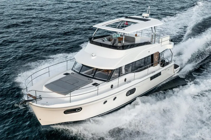 Slide: The Image of Manufacturer Provided Image: 2026 Beneteau Swift Trawler 48 cruising on open water, showcasing sleek design and spacious deck. - 2