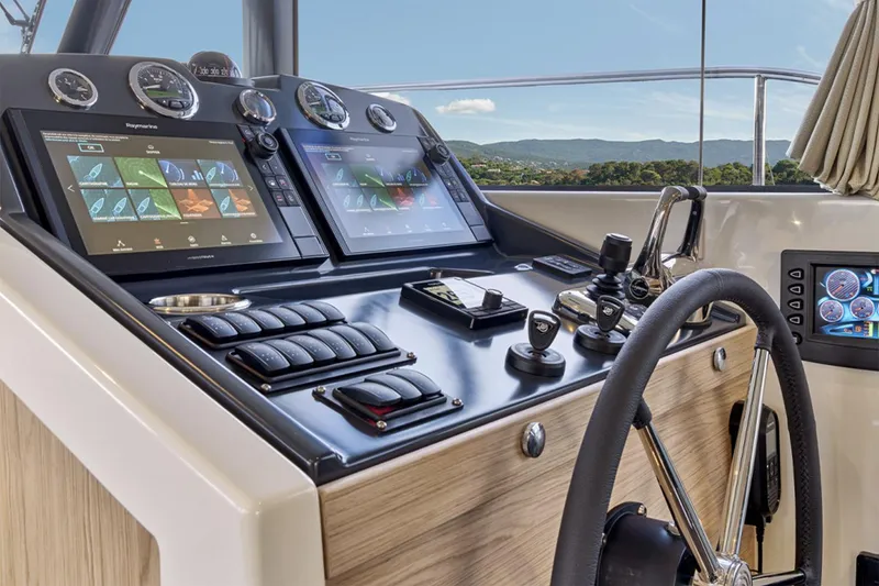 Slide: The Image of Manufacturer Provided Image: Helm of 2026 Beneteau Swift Trawler 48 with advanced navigation displays and controls. - 4