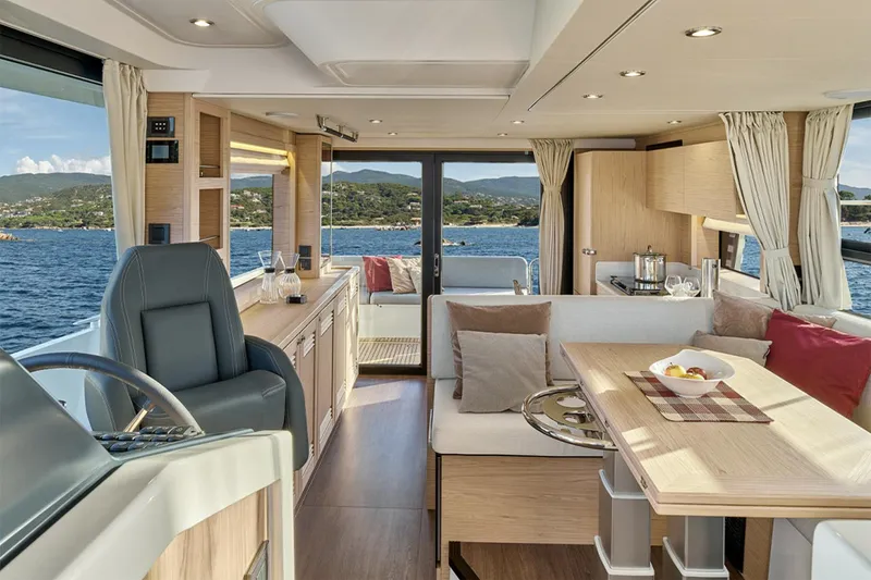 Slide: The Image of Manufacturer Provided Image: Luxurious interior of 2026 Beneteau Swift Trawler 48 with elegant seating and scenic ocean view. - 5