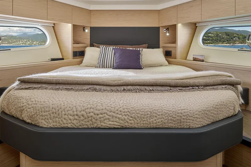 Slide: The Image of Manufacturer Provided Image: Luxurious bedroom interior of 2026 Beneteau Swift Trawler 48 with scenic window views. - 7