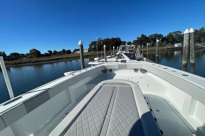 Slide: The Image of 2024 Freeman 42LR boat docked, showcasing spacious deck and sleek design. - 11