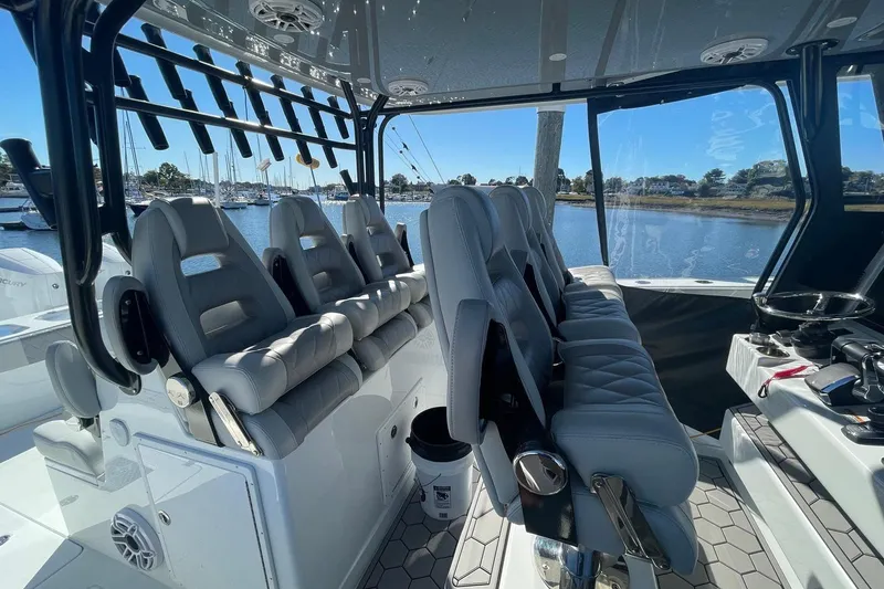 Slide: The Image of Luxurious seating on 2024 Freeman 42LR boat, docked at marina with scenic water view. - 5