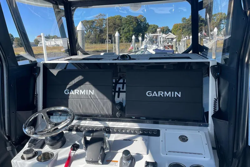 Slide: The Image of Cockpit of 2024 Freeman 42LR boat with dual Garmin displays and steering wheel. - 7