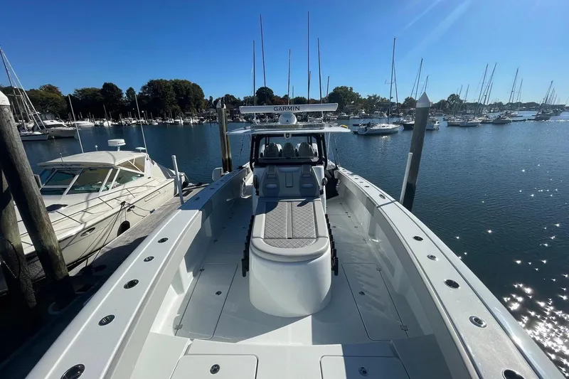 Slide: The Image of 2024 Freeman 42LR boat docked in a marina with clear blue skies. - 9