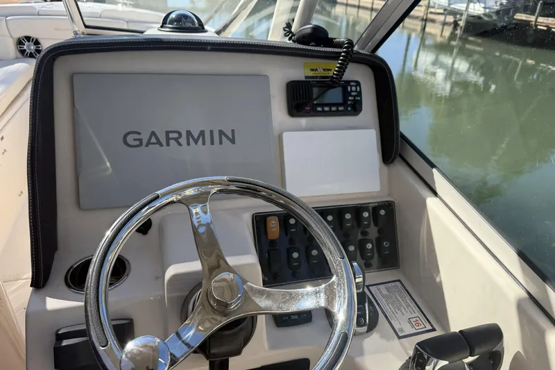 Slide: The Image of 2022 Grady-White Freedom 275 boat interior with Yamaha engines, docked by the water. - 11