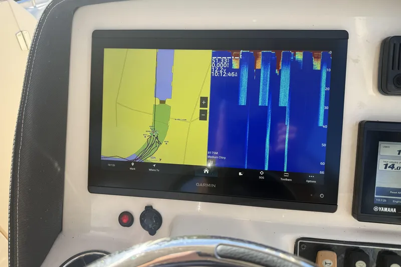 Slide: The Image of 2022 Grady-White Freedom 275 boat interior with steering console and seating. - 13