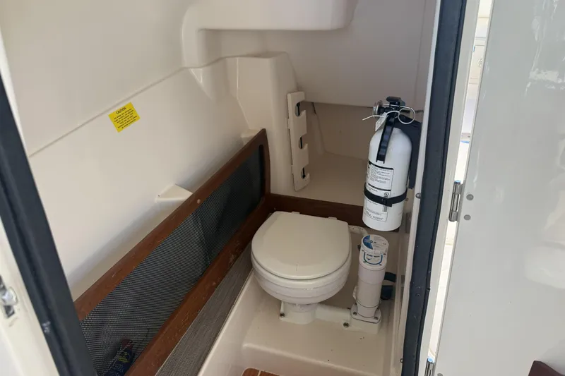 Slide: The Image of 2022 Grady-White Freedom 275 boat interior with toilet and fire extinguisher. - 25