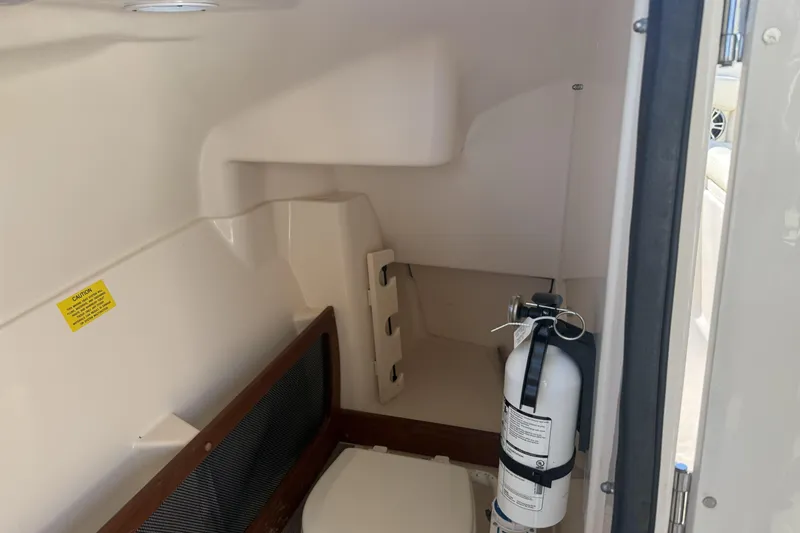 Slide: The Image of 2022 Grady-White Freedom 275 interior with fire extinguisher and storage area. - 26